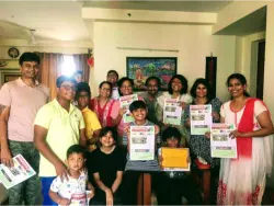 Mentees showing newspaper R Sridhar-mentored students and their parents proudly displaying their newspapers.